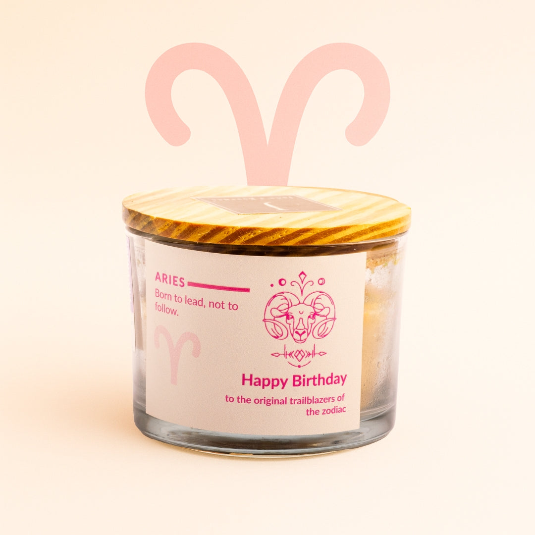 Ecofriendly Candle with Aries zodiac design on a light pink background