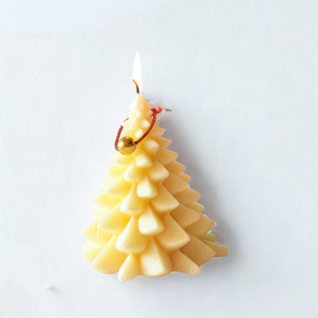 Two Christmas tree-shaped candles, one yellow and one green, with lit flames against a festive background.