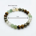 Beaded bracelet with 8mm beads on a white background citrine, pyrite, tiger eye, green aventurin healing crystals
