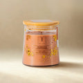 eco friendly Scented candle in a glass jar with a wooden lid on a beige background