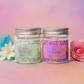 Two jars of eco friendly candles with jasmine and rose scent