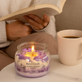Eco friendly candle labeled 'Berry Crush' with a person reading a book and a mug of coffee in the background