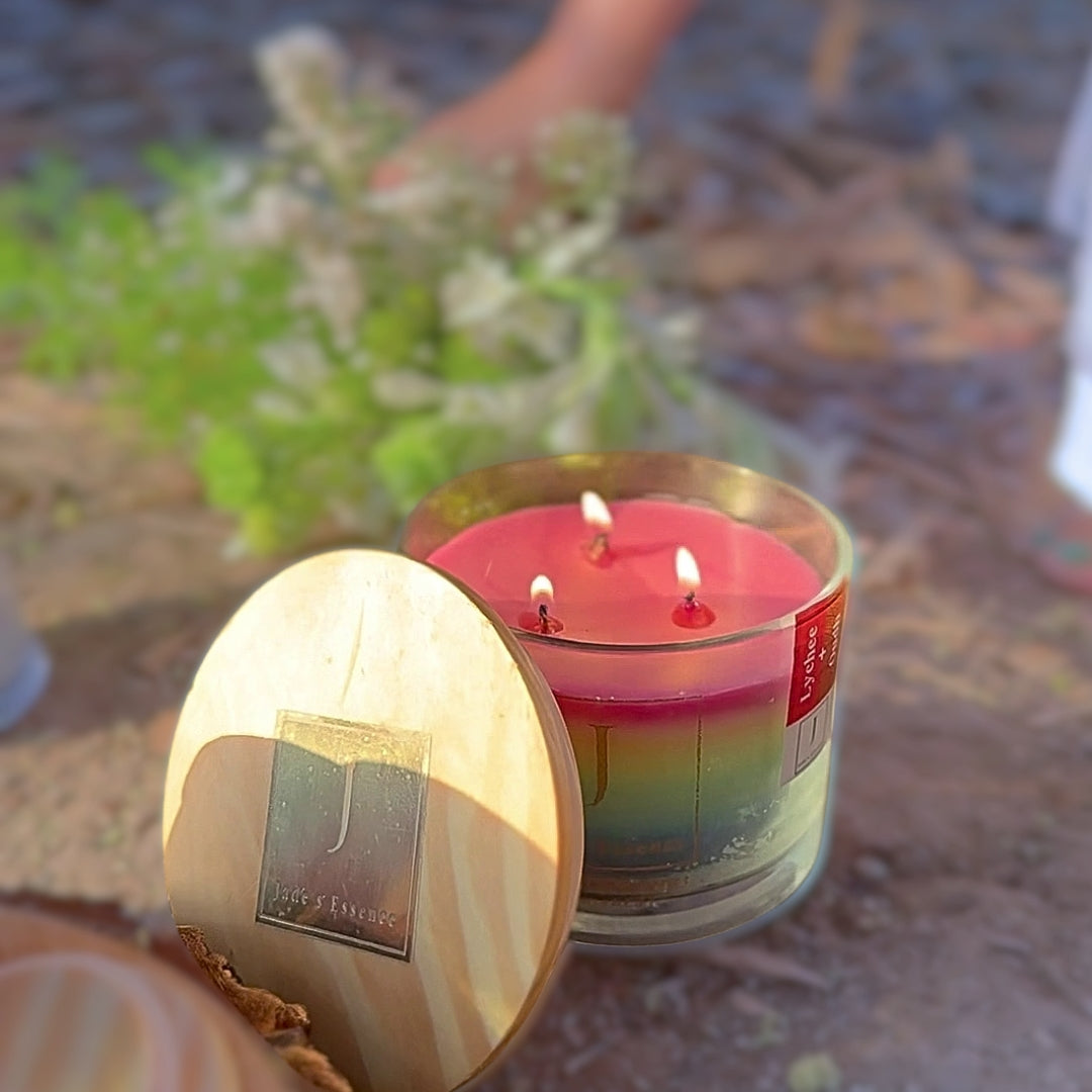 Gay and LGBTQ friendly Ecofriendly Candle with wooden lid on a textured surface with plants in the background