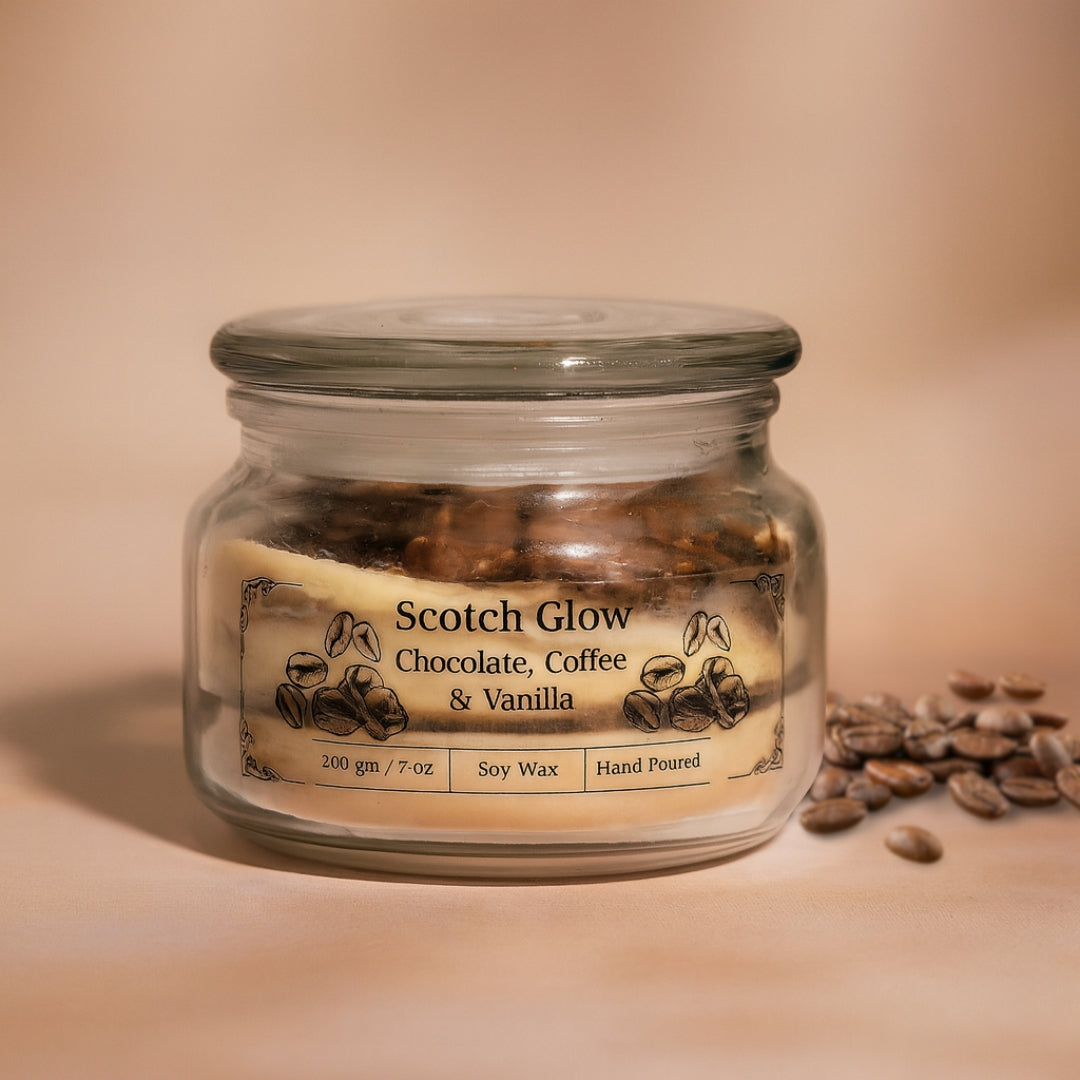 Glass jar eco friendly candle labeled 'Scotch Glow' with coffee beans on a beige background