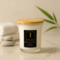 Massage candle with wooden lid on a neutral background