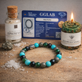 Bracelet with beaded design, Epsom salt bottle, GGLAB certificate, and candle on a textured surface.