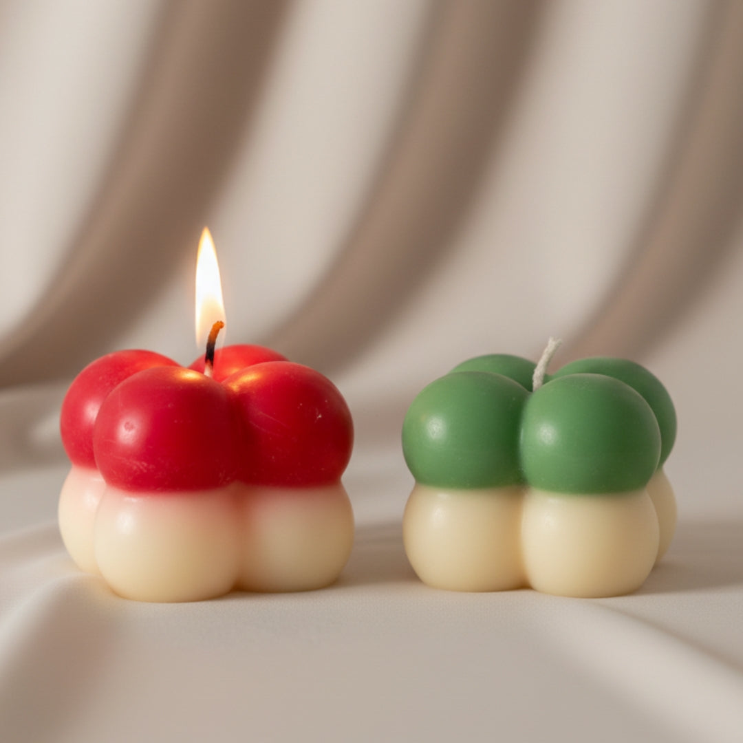 Two colorful candle designs on a neutral background