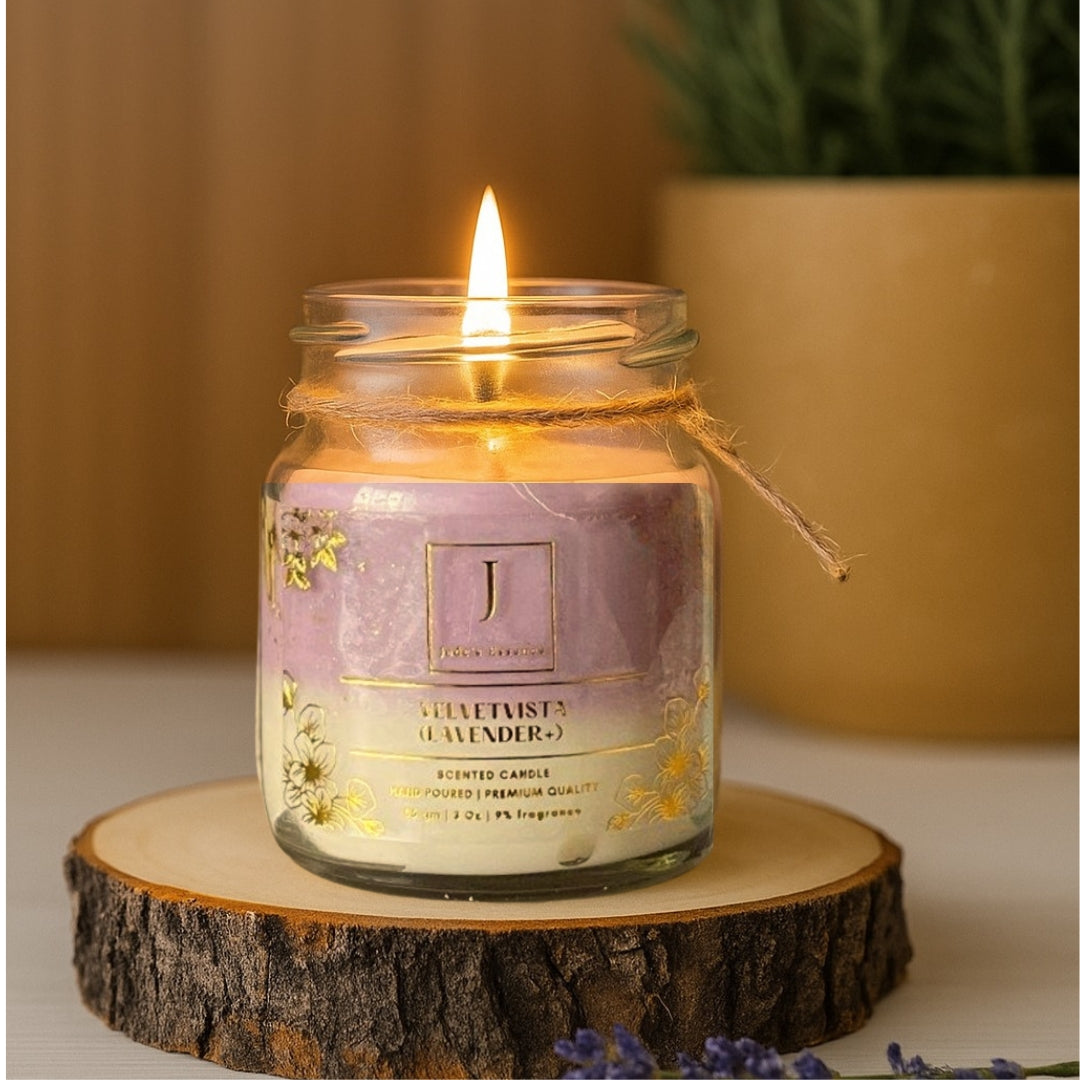 eco friendly GIFTING Candle in a glass jar with a purple label on a wooden stand, with a blurred plant in the background.
