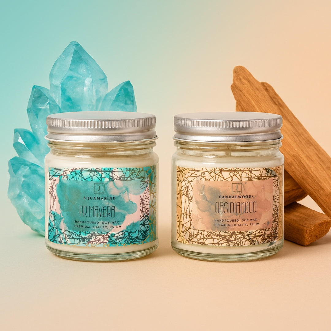Two eco friendly candles with labels featuring natural elements and crystals on a gradient background