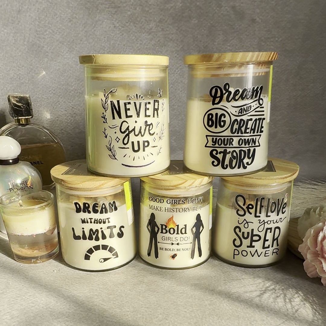 Set of ecofriendly candles with motivational phrases on a textured surface