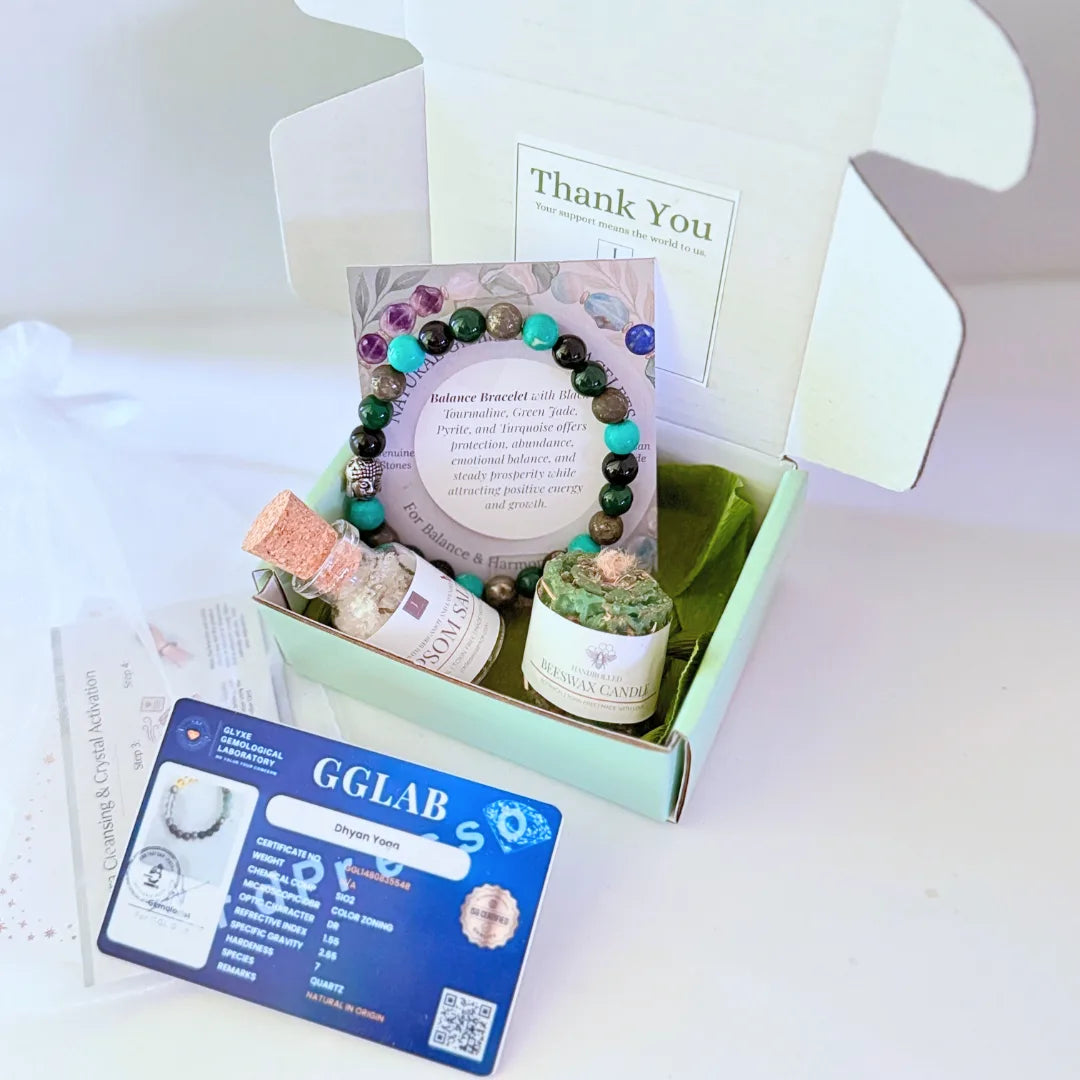 Bracelet with beaded design, Epsom salt bottle, GGLAB certificate, and candle on a textured surface.