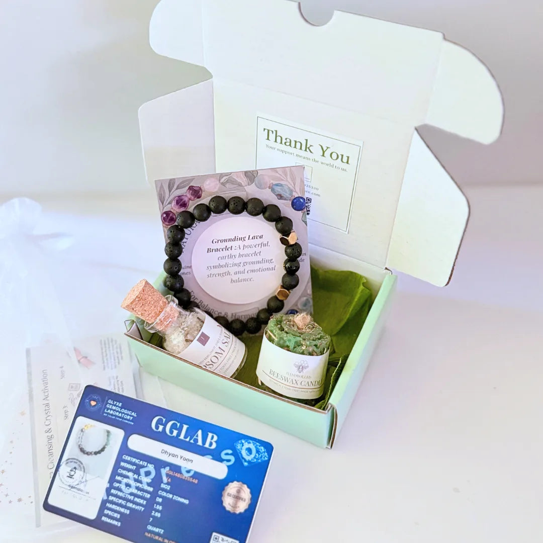 Beeswax candle, Epsom salt bottle, and bracelet on a stone surface with a GGLAB card in the background.