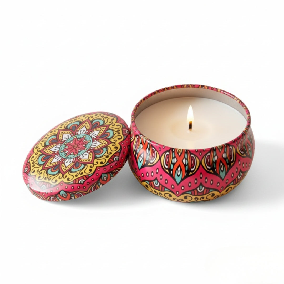 Colorful patterned candle in a tin with a lit candle inside on a white background
