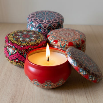 Decorative candles with colorful lids on a wooden surface