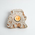 Decorative candle holder shaped like an elephant with intricate patterns on a light gray background