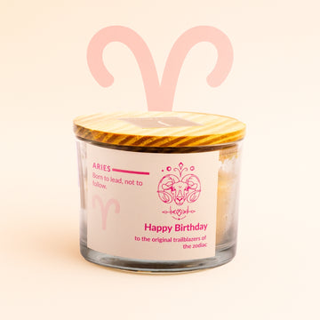 Ecofriendly Candle with Aries zodiac design on a light pink background