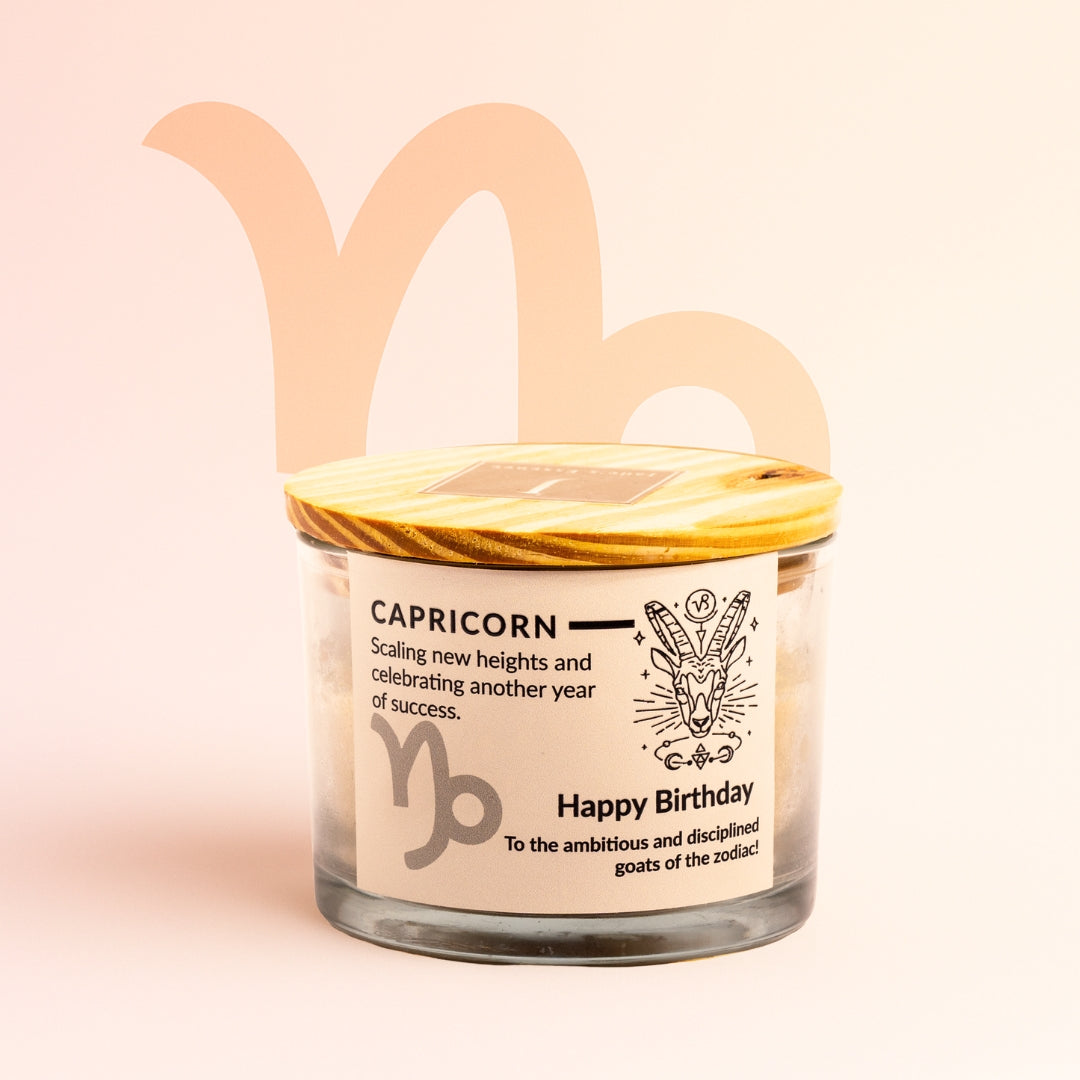 ecofriendly Candle jar with Capricorn design and text on a light pink background