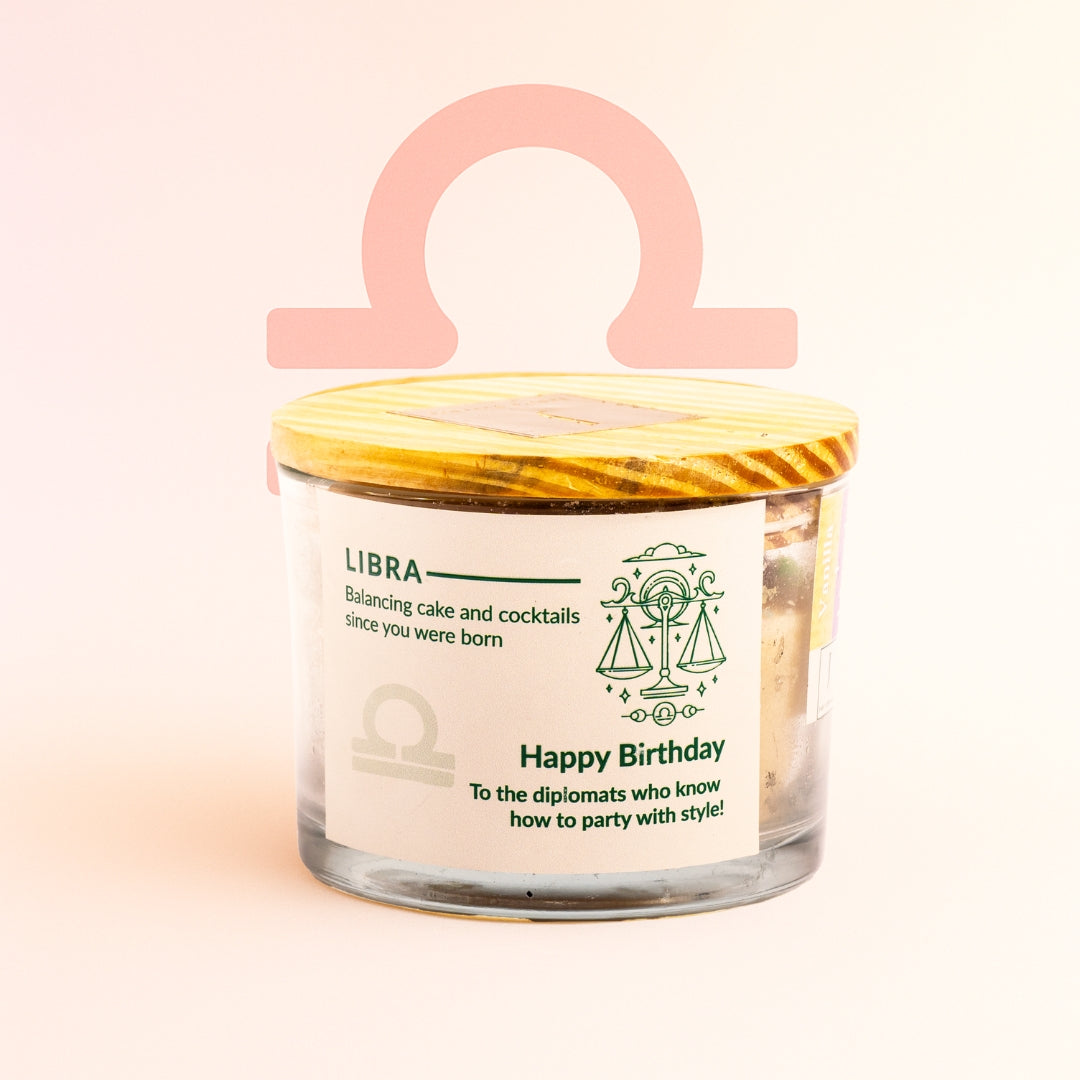 ecofriendly Candle in a glass jar with a yellow lid, featuring Libra zodiac sign design on a light pink background. Zodiac candle eco friendly 