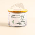 ecofriendly Candle jar with a label for Pisces birthday wishes on a beige background